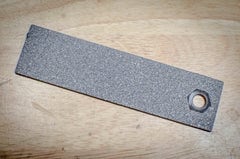A sample plate used in thermal spray coating microstructure analysis
